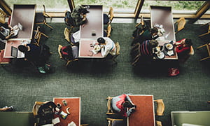 Aerial view of individual eating at the Trillium Dining Hall. 