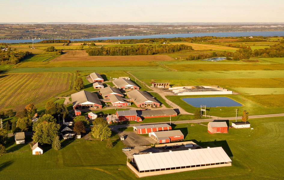 An aerial view of farm buildings near the one of the Finger Lakes.